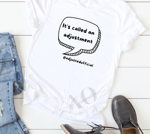 white t shirt with black letters in a word bubble. Words say, "It's called an adjustment"