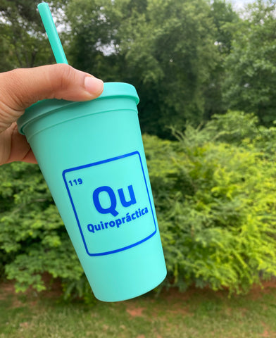 16oz teal tumbler with letters Qu and words Quiropractica inside. Number 119 on top right corner. Words are inside a square shaped like element on periodic table
