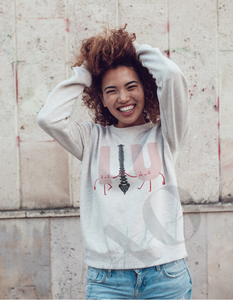 woman with both hands on her head smiling in a white crewneck crewneck sweater that says  I spine you 